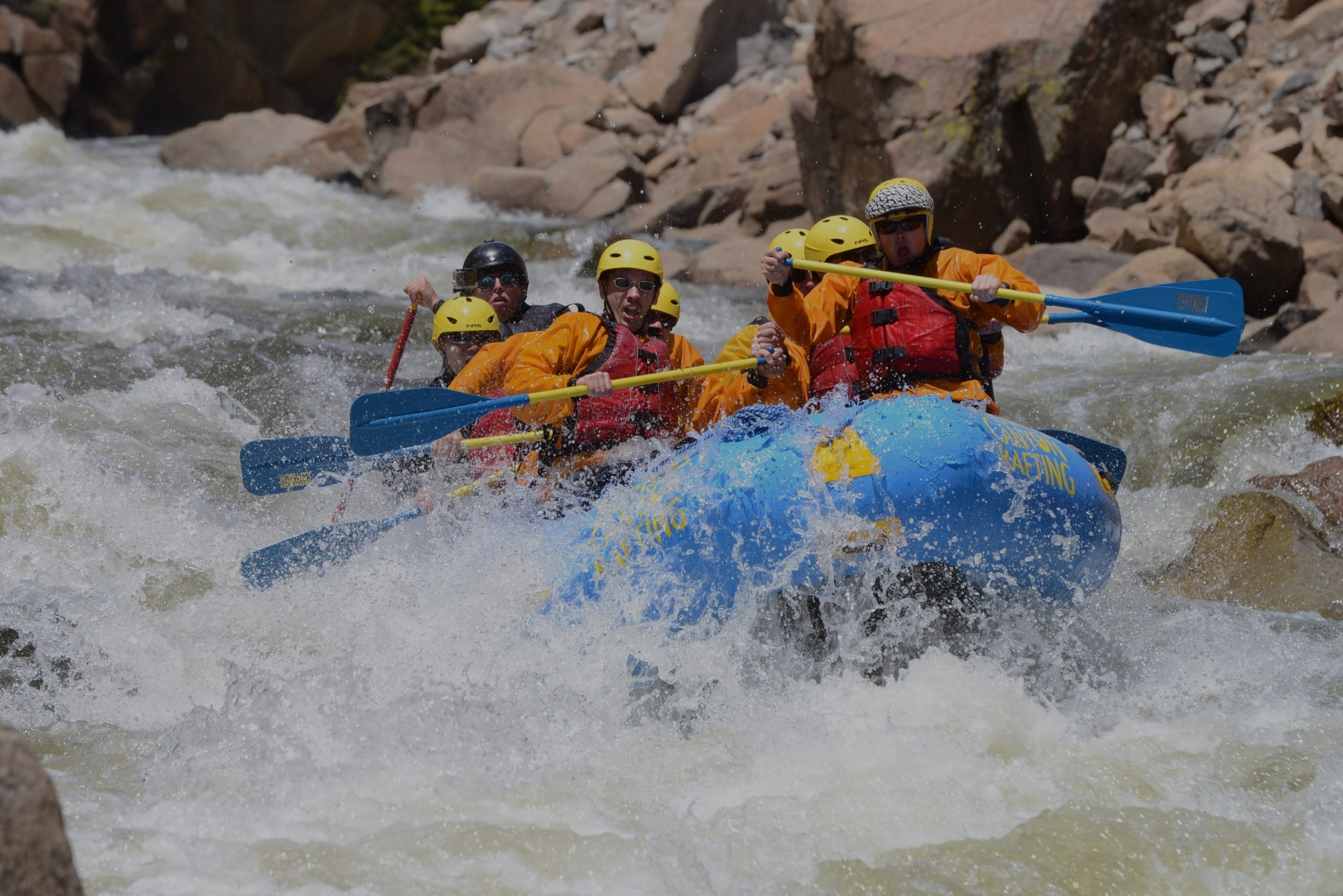 Expert-level rafters navigating fast-moving Class IV-V whitewater rapids during an advanced rafting trip in Colorado with Browns Canyon Rafting.