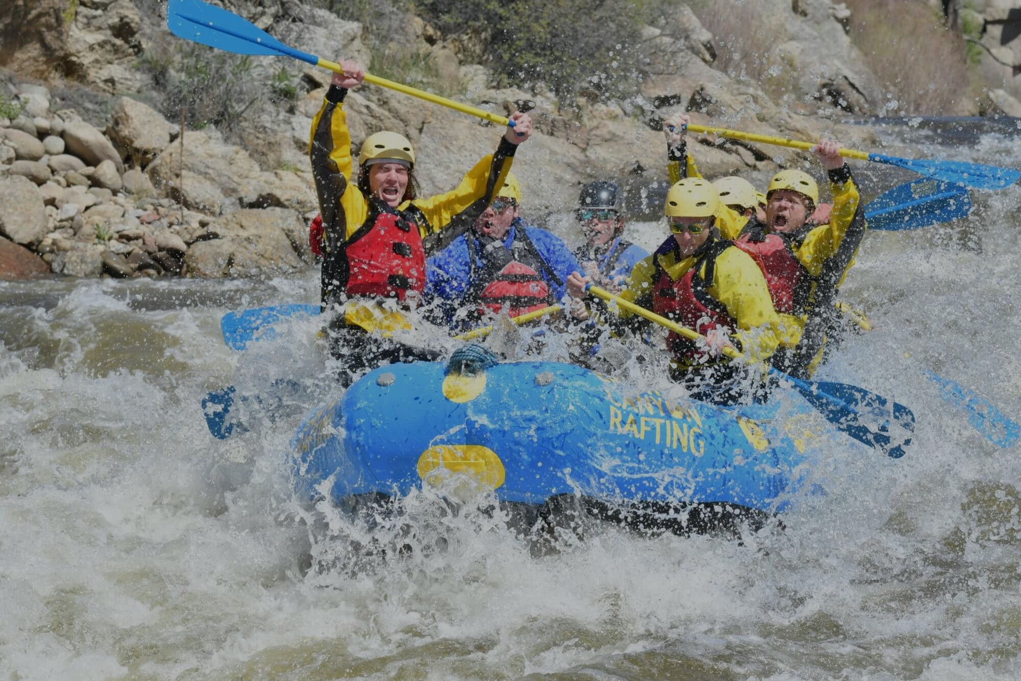 Experienced rafters riding bouncy Class III-IV rapids on an intermediate rafting trip in Colorado.