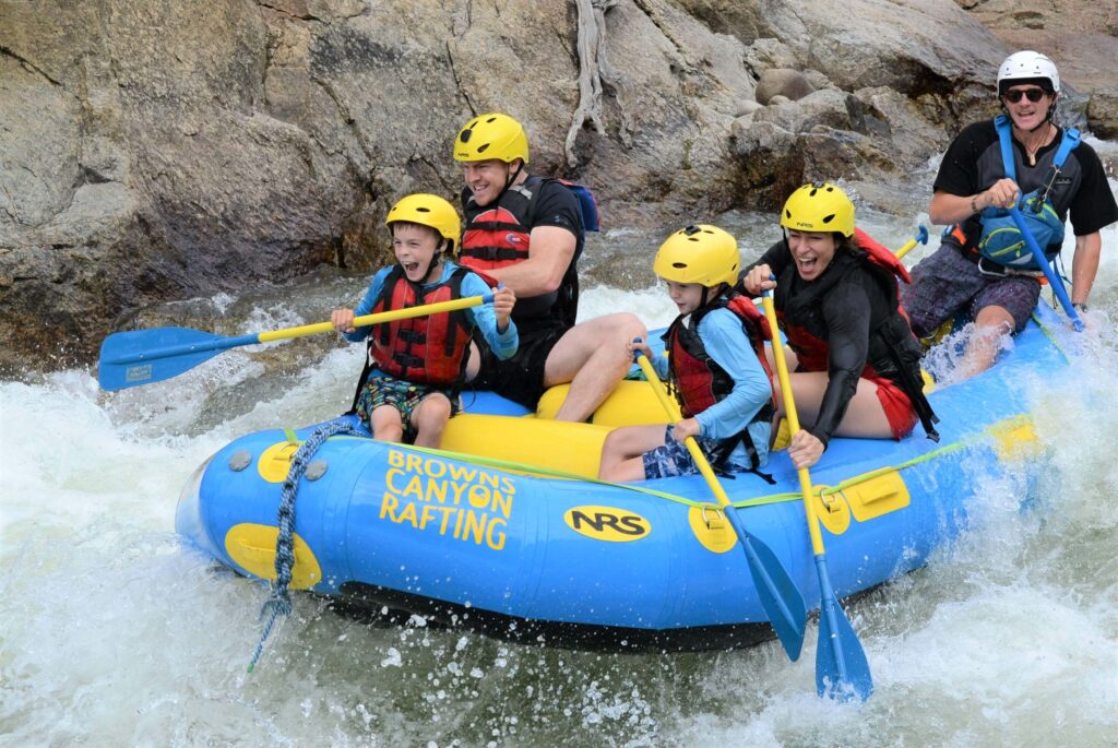 late season upper colorado river Group of rafters paddling through foamy whitewater rapids on a sunny day late season.