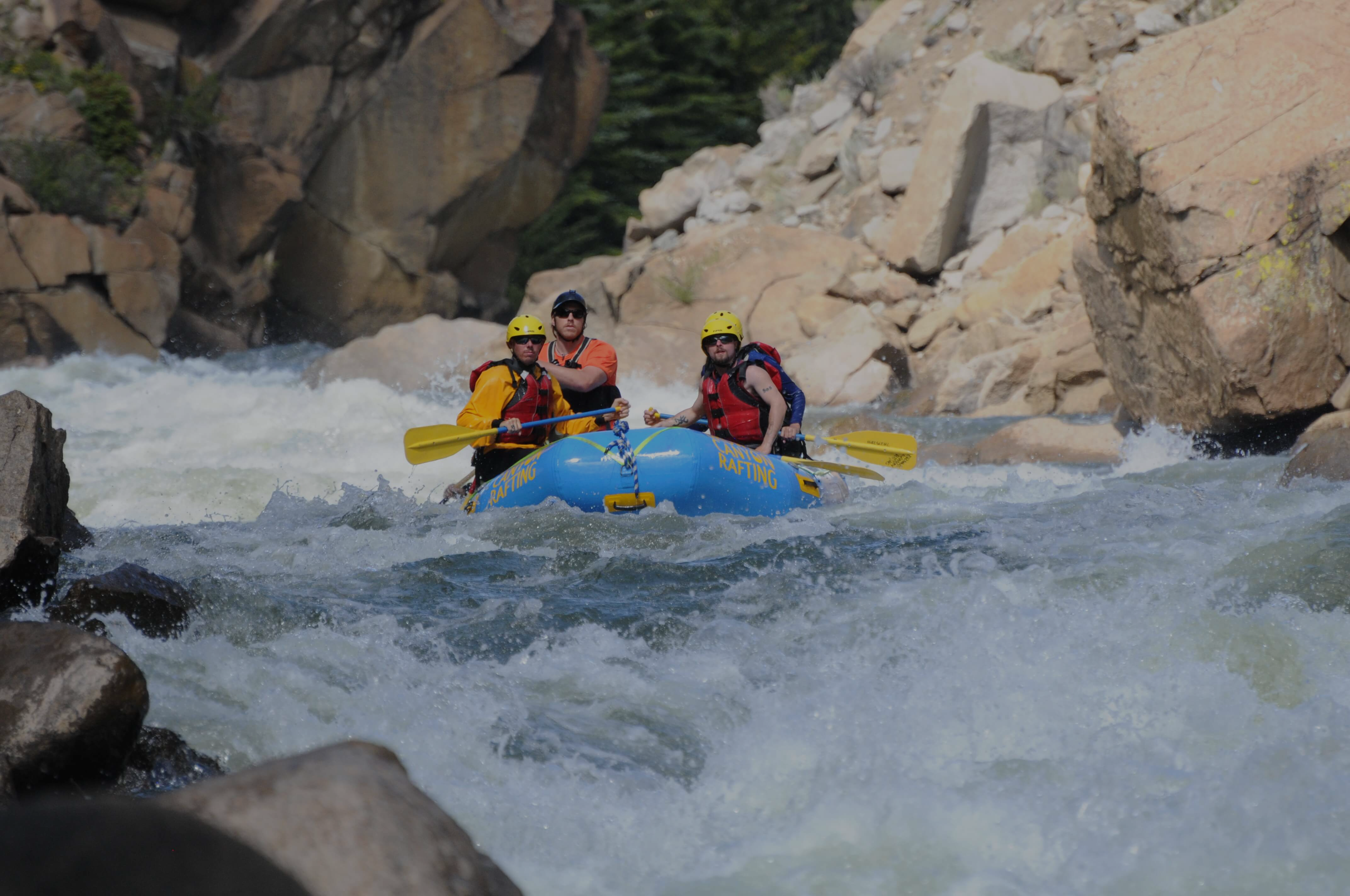 Rafters charging through Class V rapids on a Pine Creek full day rafting trip on the upper Arkansas River.